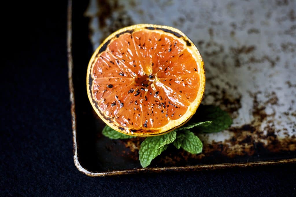 broiled grapefruit on a sheet pan with mint