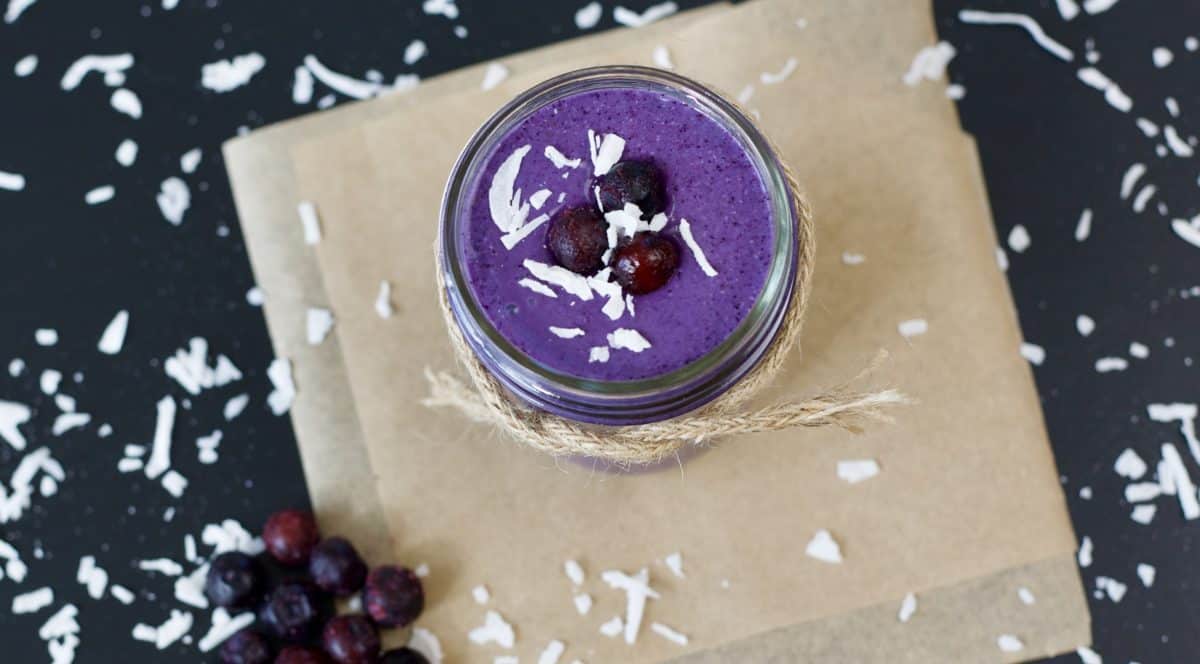 coconut blueberry smoothie with frozen blueberries and shredded coconut