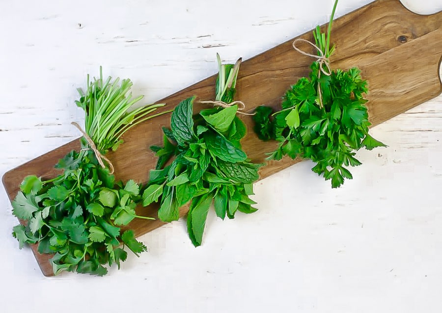 fresh herbs on a cutting board for cauliflower rice tabbouleh