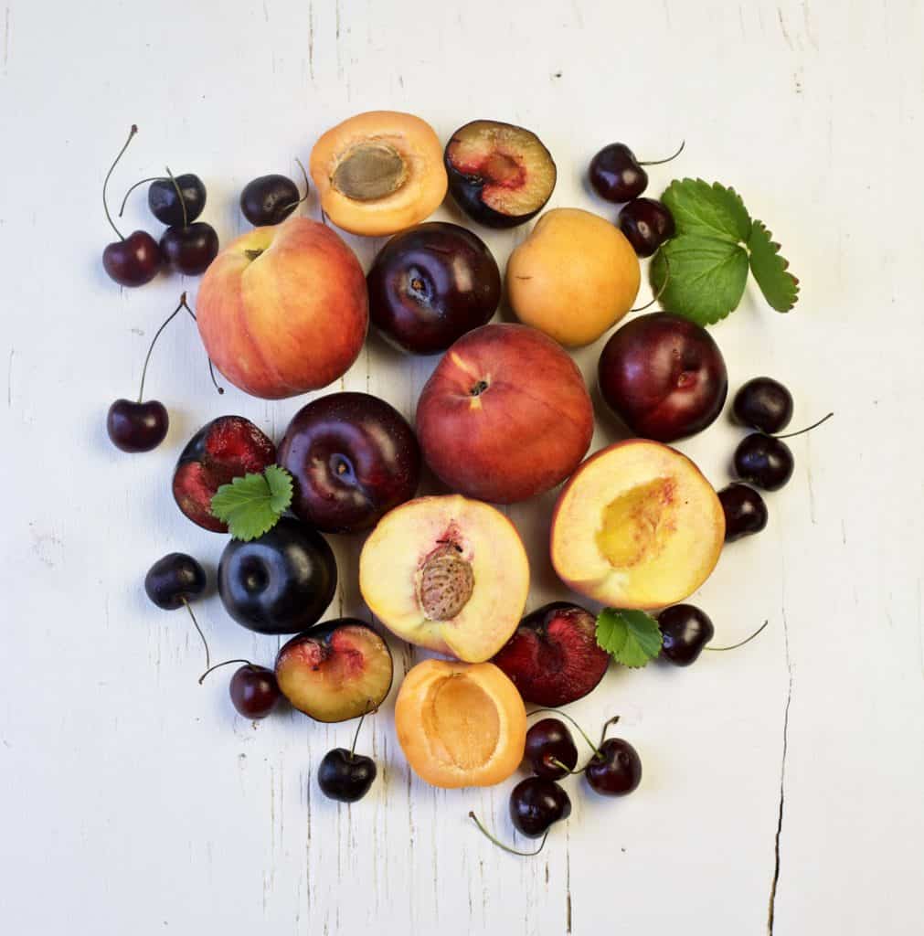 stone fruits on a white table