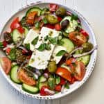 bowl of greek salad topped with feta cheese