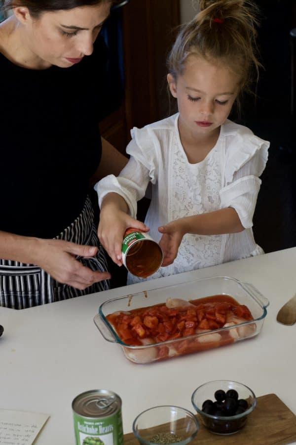 little girl helping make dinner with mom