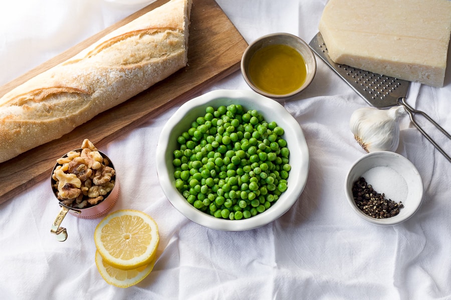 spring pea pesto ingredients - frozen peas, walnuts, bread, olive oil, parmesan, garlic