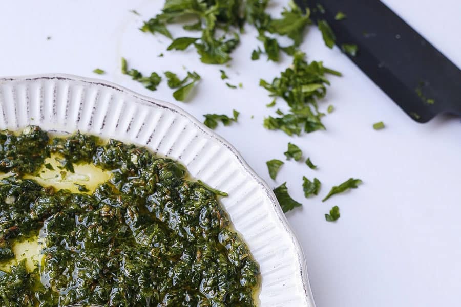 close up of middle eastern chermoula sauce with chopped herbs