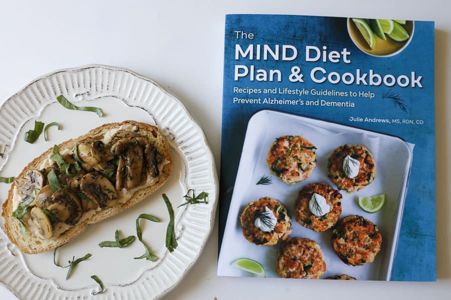 the MIND diet cookbook next to mushroom toast on plate