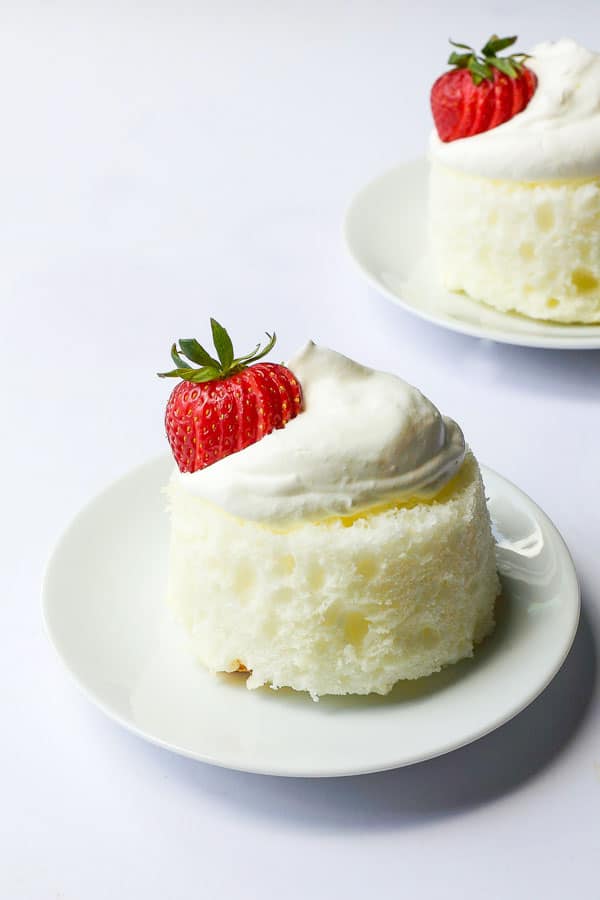 mothers day dessert - mini angel food cakes topped with strawberries and homemade almond whipped cream