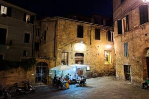 late night group of people eating in streets in italy