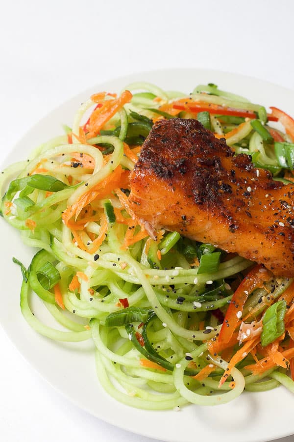 grilled cedar plank salmon on top of mixed vegetables