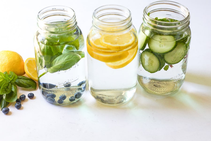 blueberry basil water and other fruit infused water in glass jars