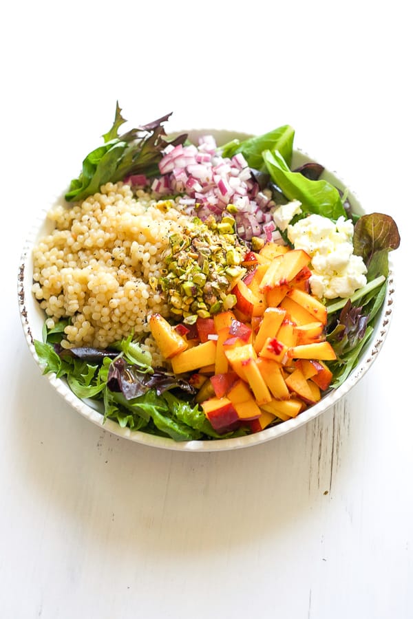 bowl of fresh summer peaches in a mediterranean diet inspired salad