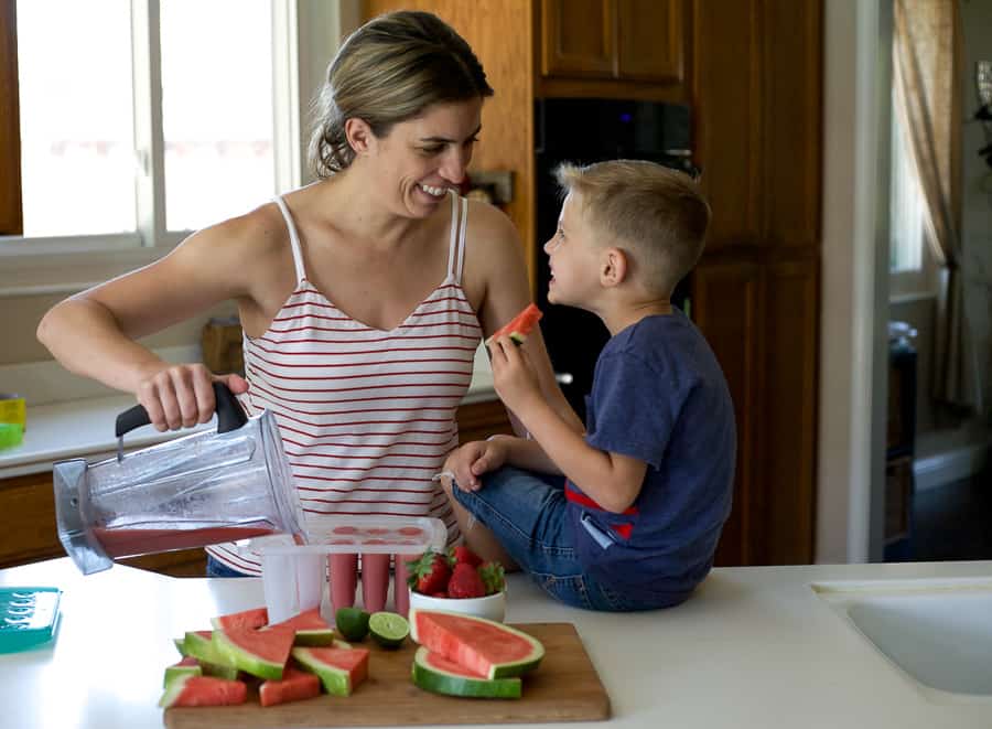 mother and son cooking in kitchen together