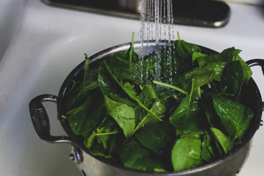 spinach leaves being washed