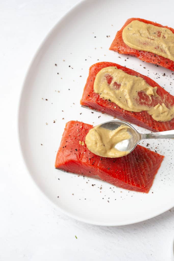 adding dijon mustard to cast iron salmon