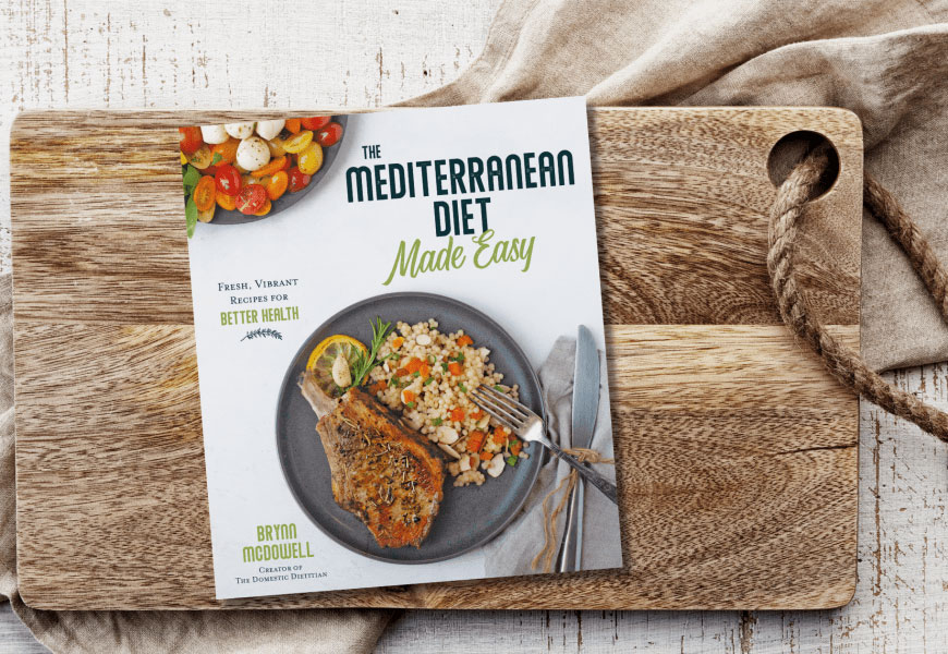 Mediterranean Diet made easy cookbook on cutting board 